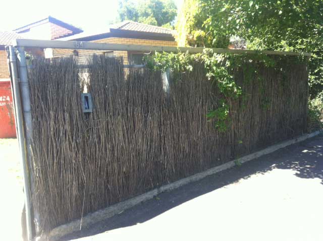 Image:   The brushwork in this fence should be replaced.  The posts and base are still in good condition and can be re-used.