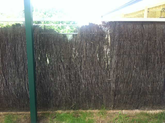 Image:   The brushwork in this fence should be replaced with new machine compressed never-sag panels.  The posts and base are still in good condition and can be re-used.