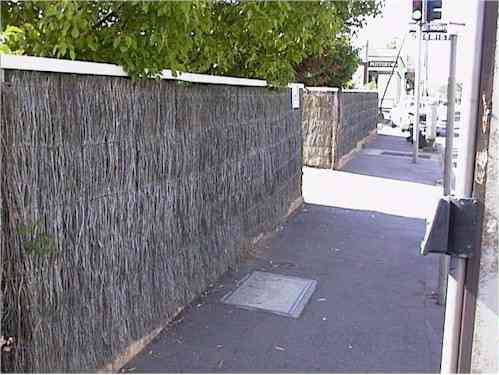 Image:  Hand packed brush fences can also be knocked off their bases by car  eg in unit complexes where where car ports have a brush boundary fence in front of it. 